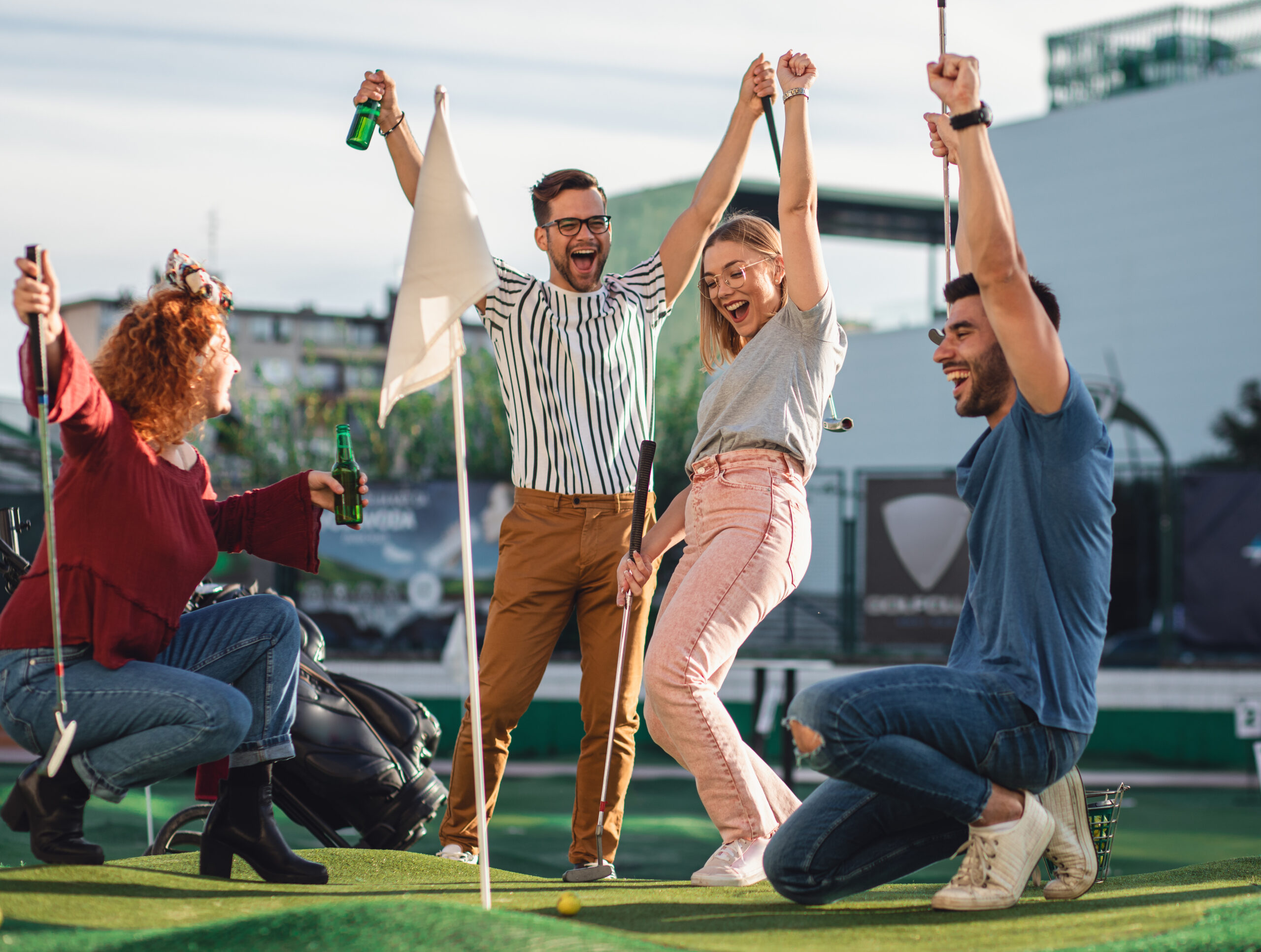 People celebrating a mini golf put